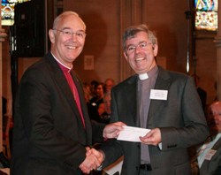 Archdeacon Stephen Forde accepts Connor's award for runner up in the Diocesan website category from Archbishop Harper.